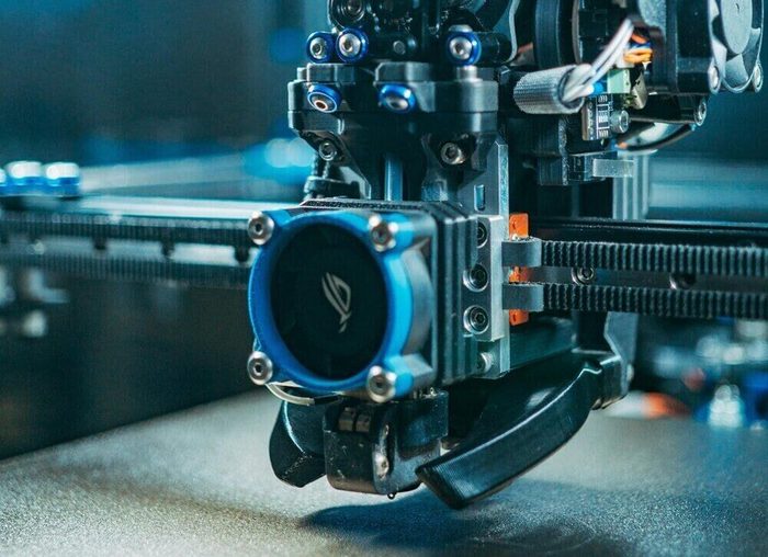 A 3D printer producing face shield frames for the 3DPPE GTHA initiative